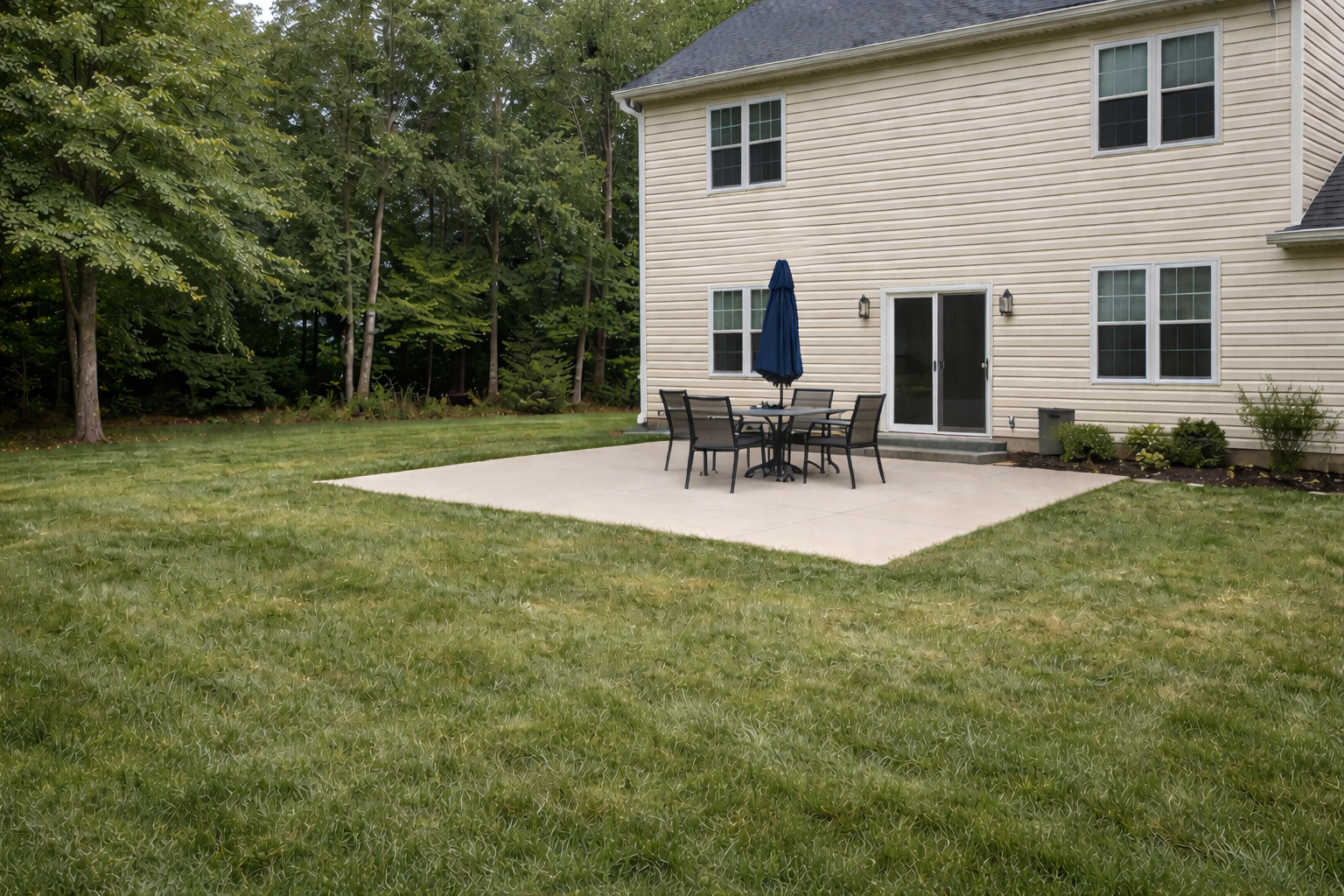 Before: plain concrete patio with basic furniture